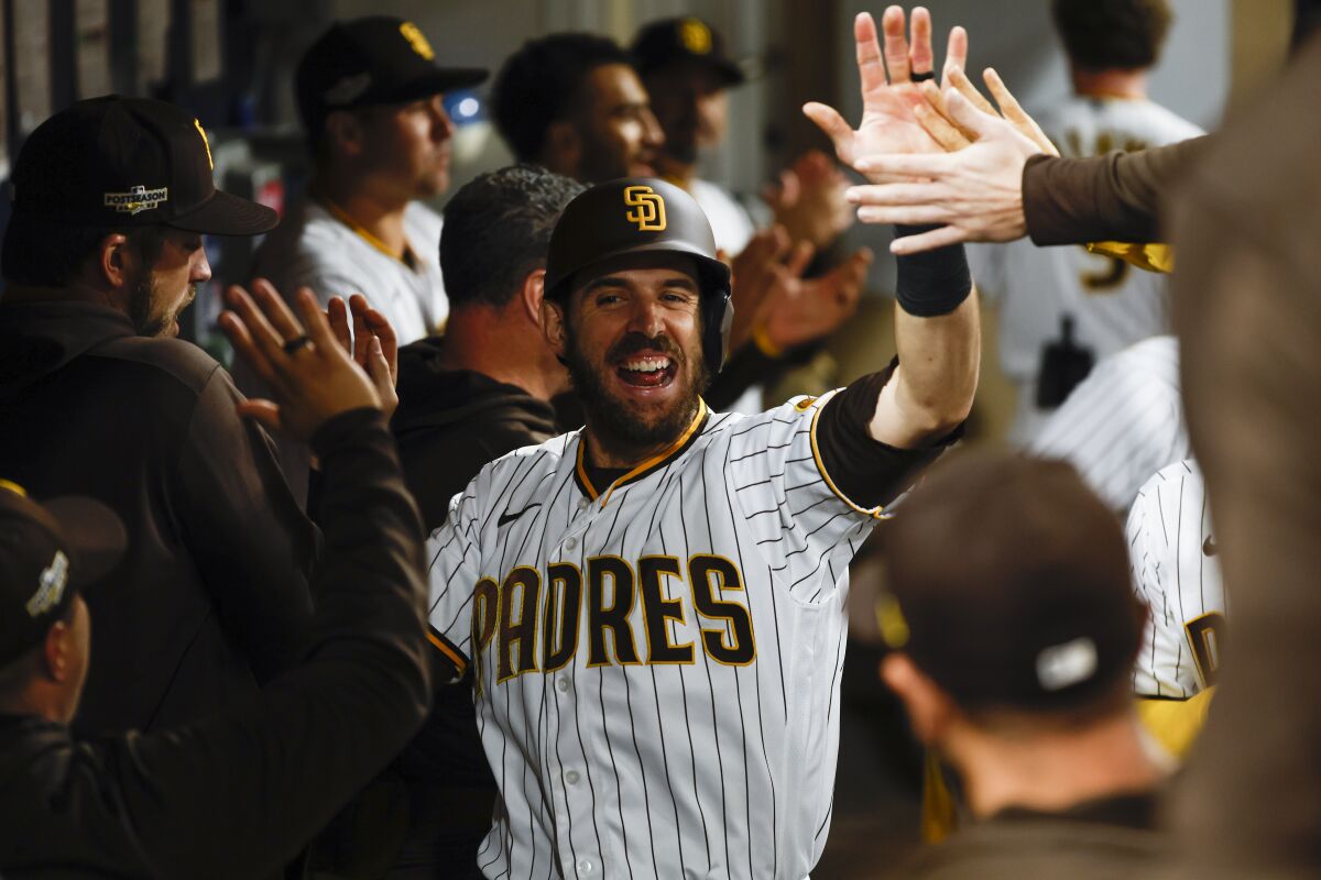 Padres catcher Austin Nola celebrates in the dugout after scoring a run during Game 4 of the division series. 