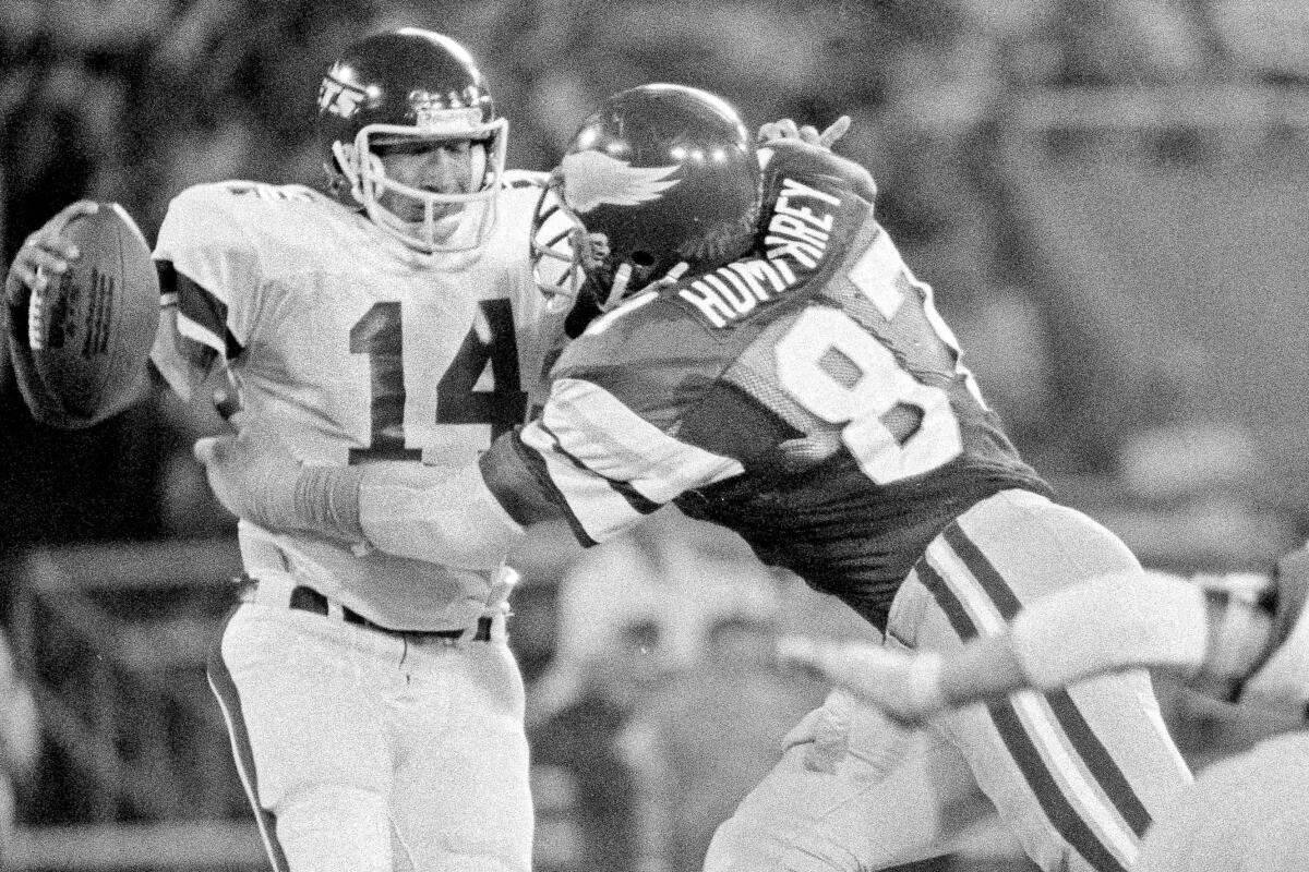 Claude Humphrey, while playing for the Eagles, pressures Jets quarterback Richard Todd.