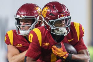 USC quarterback Miller Moss, left, hands off to running back Quinten Joyner against LSU.