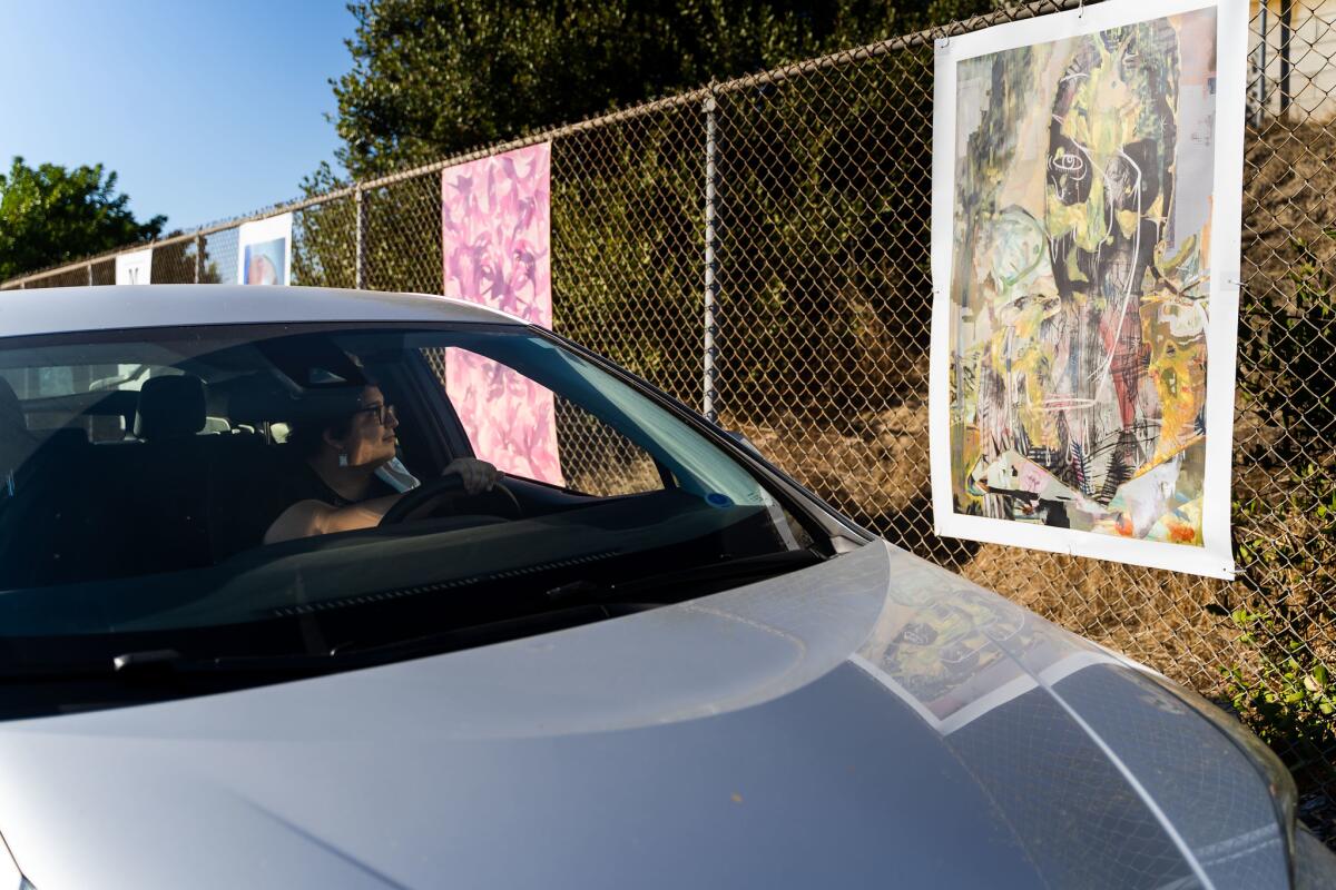 A driver takes in one of the pieces in Mesa College's drive-thru art exhibition "Mesa Drive-In," on display through Dec. 9.