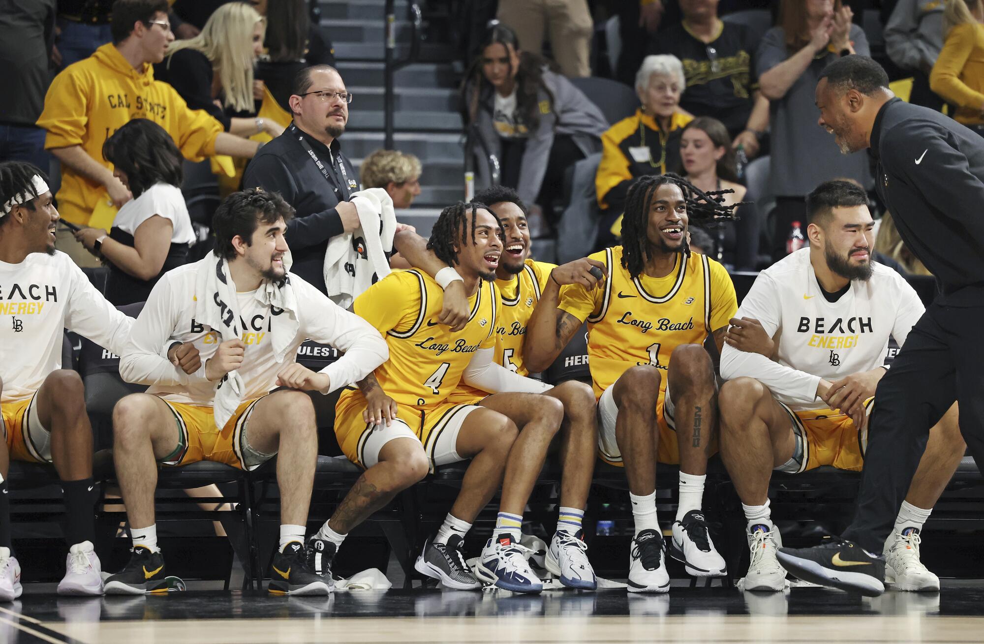 Long Beach State players cheer on the sidelines.