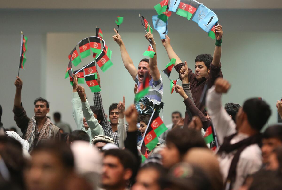 Supporters of Afghanistan presidential candidate Abdullah Abdullah cheer during a campaign rally in Kabul.