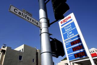 A California Street sign is shown next to a gas price board at an Exxon station during the coronavirus outbreak in San Francisco, Thursday, May 7, 2020. (AP Photo/Jeff Chiu)