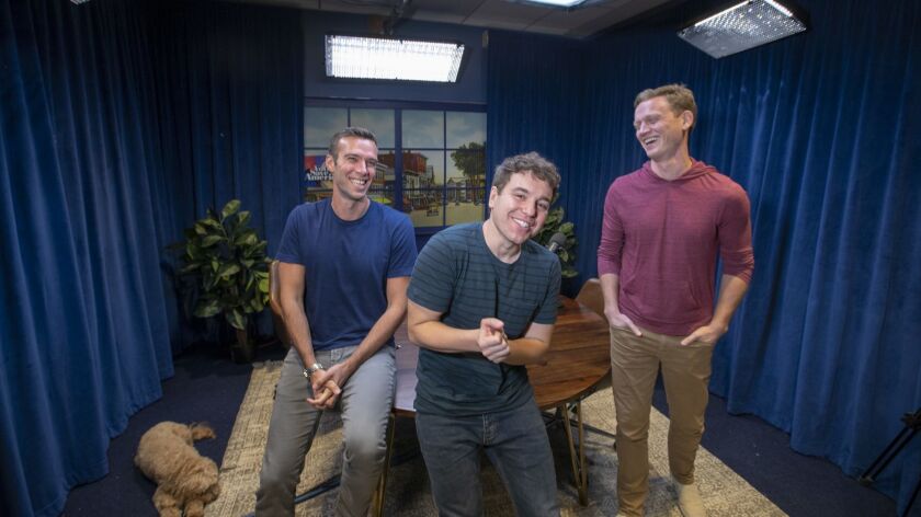 The goldendoodle Leo, left, with former White House staffers under President Obama Jon Favreau, Jon Lovett and Tommy Vietor, who host the hit politics podcast "Pod Save America," which arrives on HBO for a limited run of live shows timed for the midterm elections on Oct. 12.