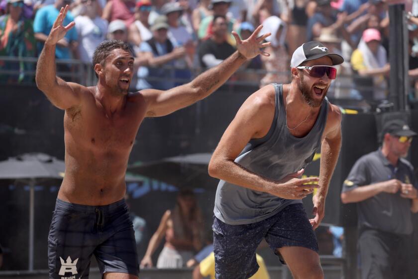 Mahattan Beach, CA - August 18: Trevor Crabb, left, and Theo Brunner, right, celebrate their a win.