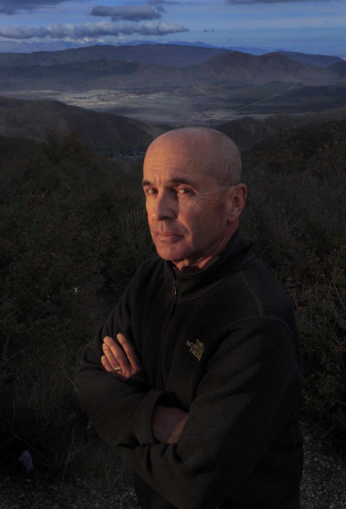 A headshot of a man in the dark