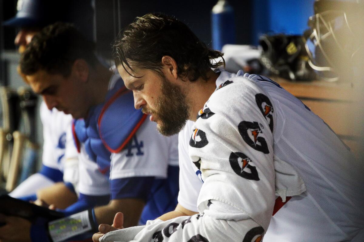 Dodgers pitcher Clayton Kershaw sits in the dugout after suffering a season-ending injury.