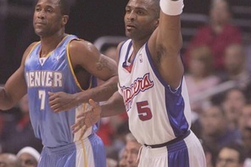 Clipper guard Cuttino Mobley, right, throws a fist in the air after hitting a three-pointer during first quarter of Monday's 101-83 victory over the Denver Nuggets at Staples Center.