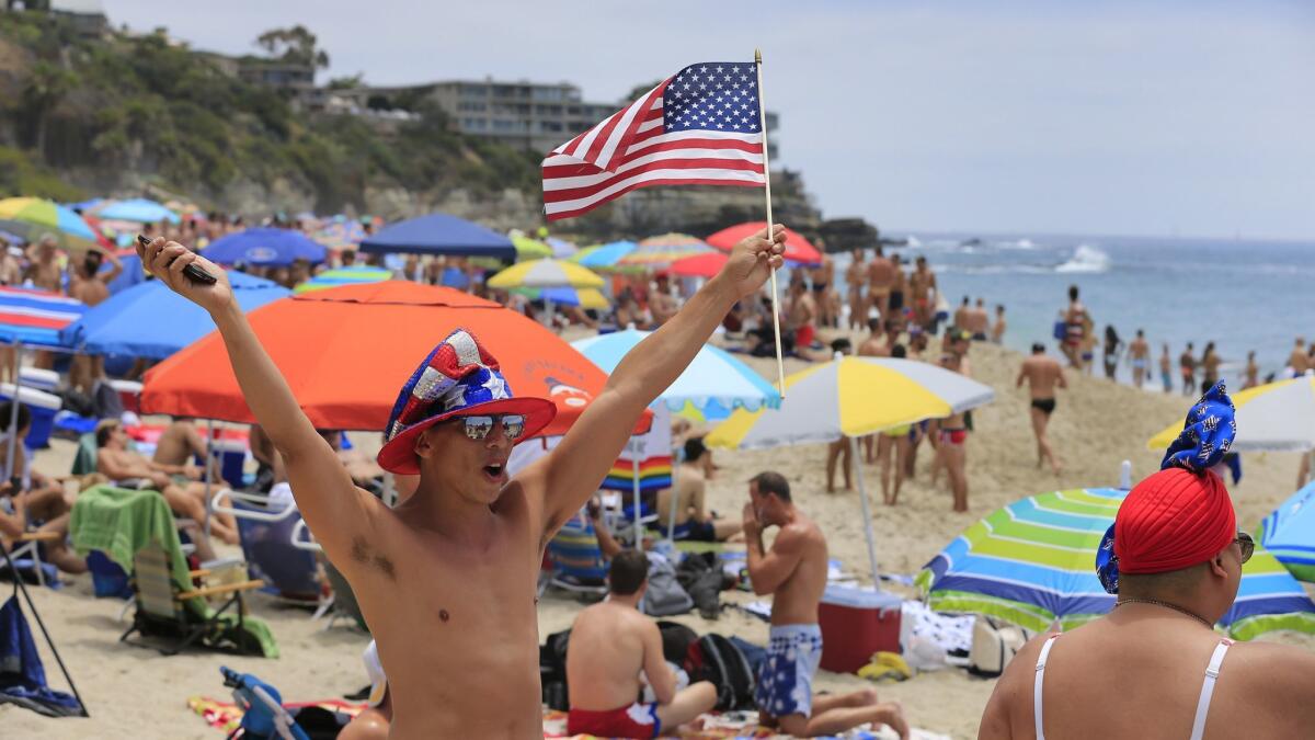 A man waves an American flag in Laguna Beach, Calif. on July 4, 2015.