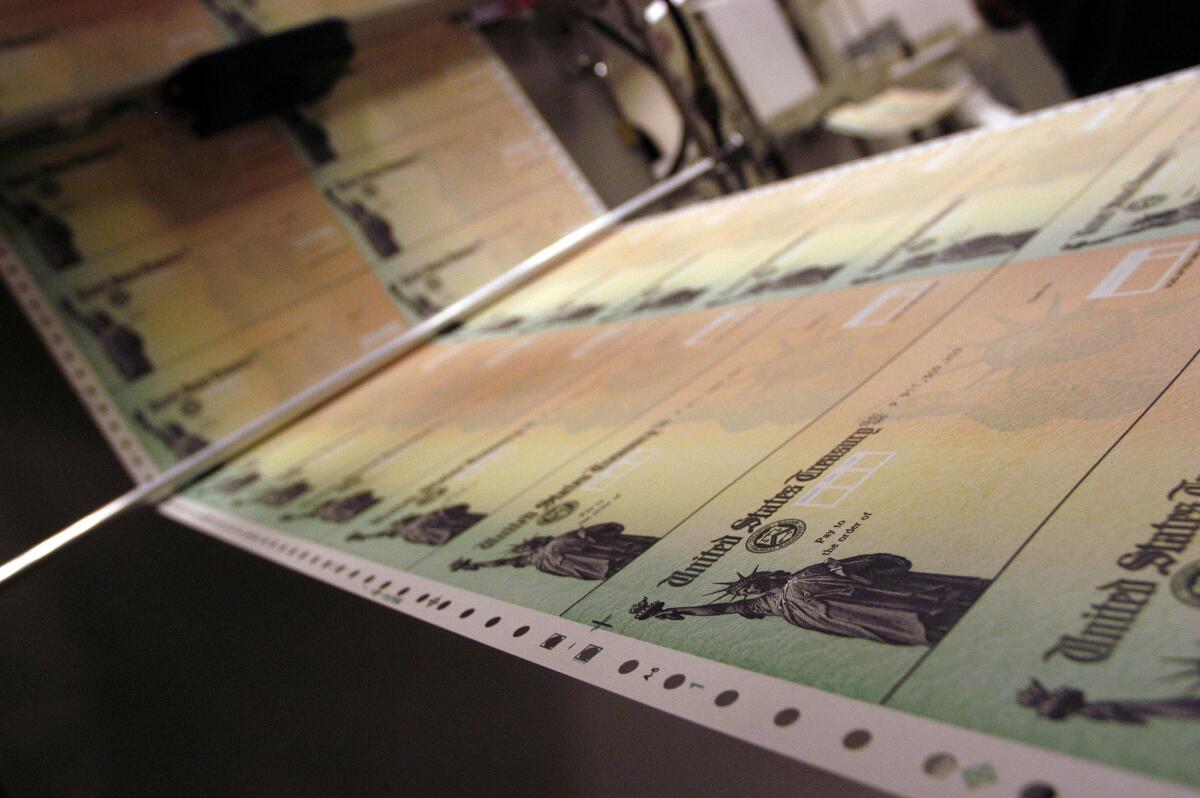 Blank Social Security checks are run through a printer at the U.S. Treasury printing facility in Philadelphia in 2005.