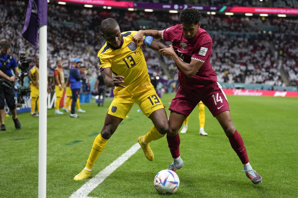 Two players struggle for control of the soccer ball.