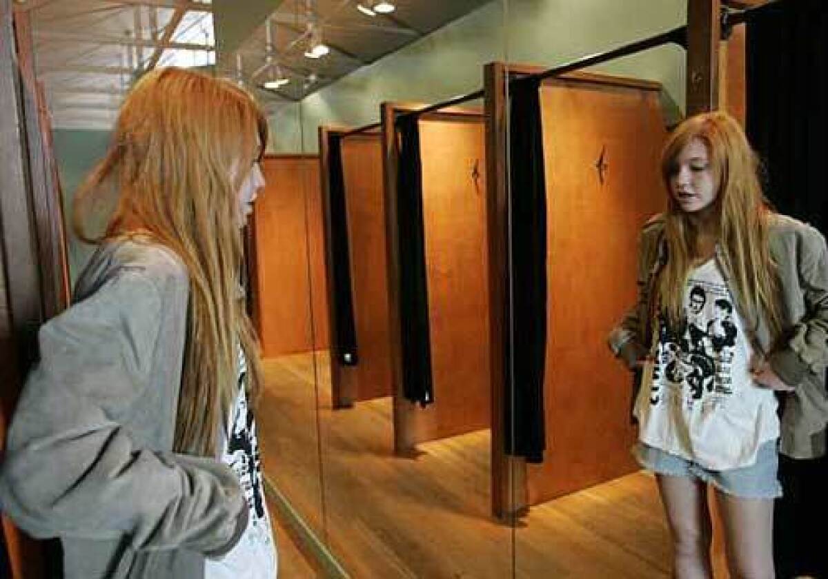 Maddy Chais, 15, checks out a T-shirt and jacket at Wasteland, a vintage clothing store on Melrose Avenue. The current economic woes have ushered in the hottest fashion trend of the season, Thrifty Chic, and sent hipsters to thrift shops and discount outlets in search of vintage duds.