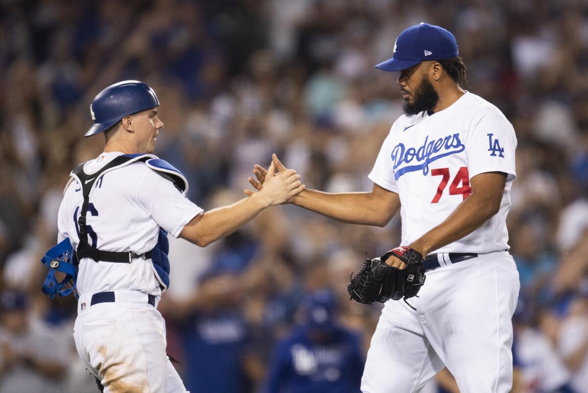 Los Angeles Dodgers catcher Will Smith , left, and relief pitcher Kenley Jansen celebrate the team's 5-4 win over the San Diego Padres in a baseball game in Los Angeles, Saturday, Sept. 11, 2021. (AP Photo/Kyusung Gong)