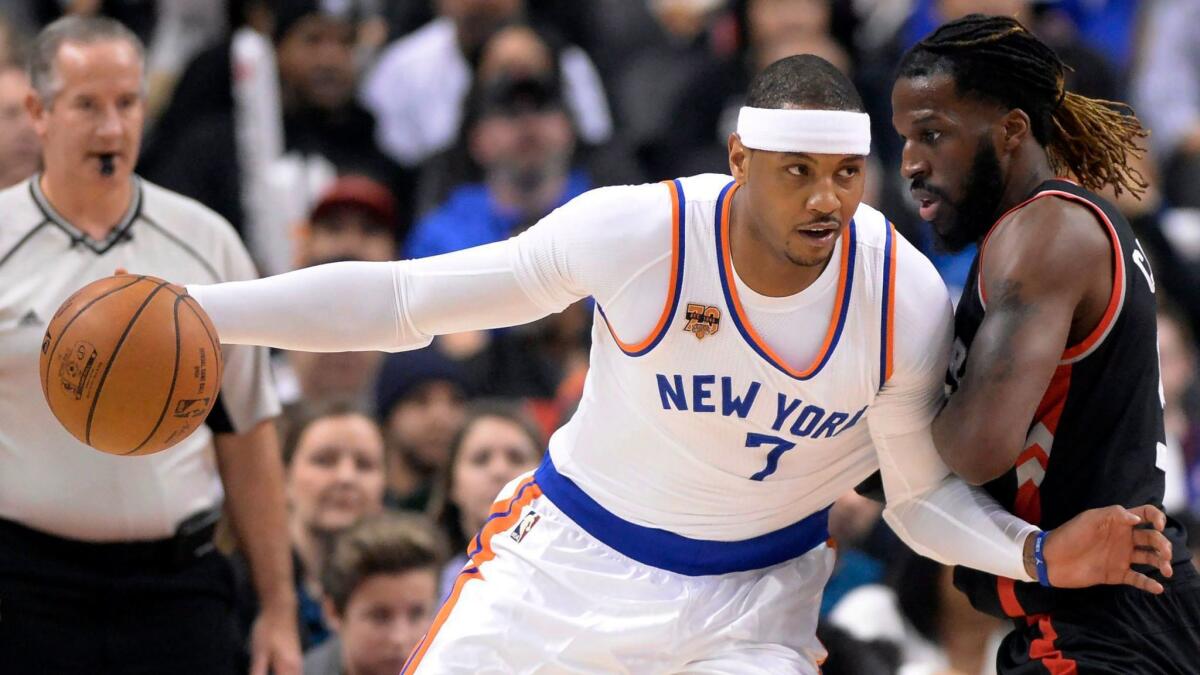 New York forward Carmelo Anthony leans in against Toronto forward DeMarre Carroll on Jan. 15.