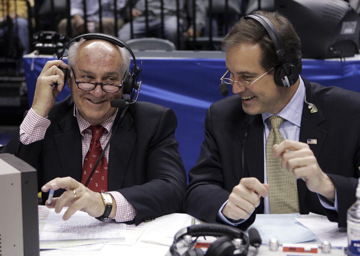 Announcers Billy Packer, left, and Jim Nantz laugh during a break in the Big Ten basketball tournament.
