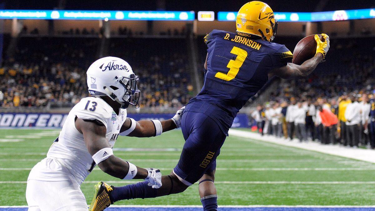 Toledo wide receiver Diontae Johnson (3) catches the ball for a touchdown past Akron defensive back Denzel Butler (13) during the second quarter of the Mid-American Conference championship on Saturday.