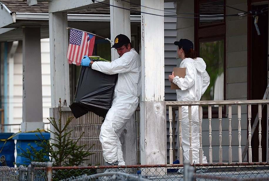 FBI forensic personnel remove evidence from the Cleveland house where three women allegedly were held captive for a decade.