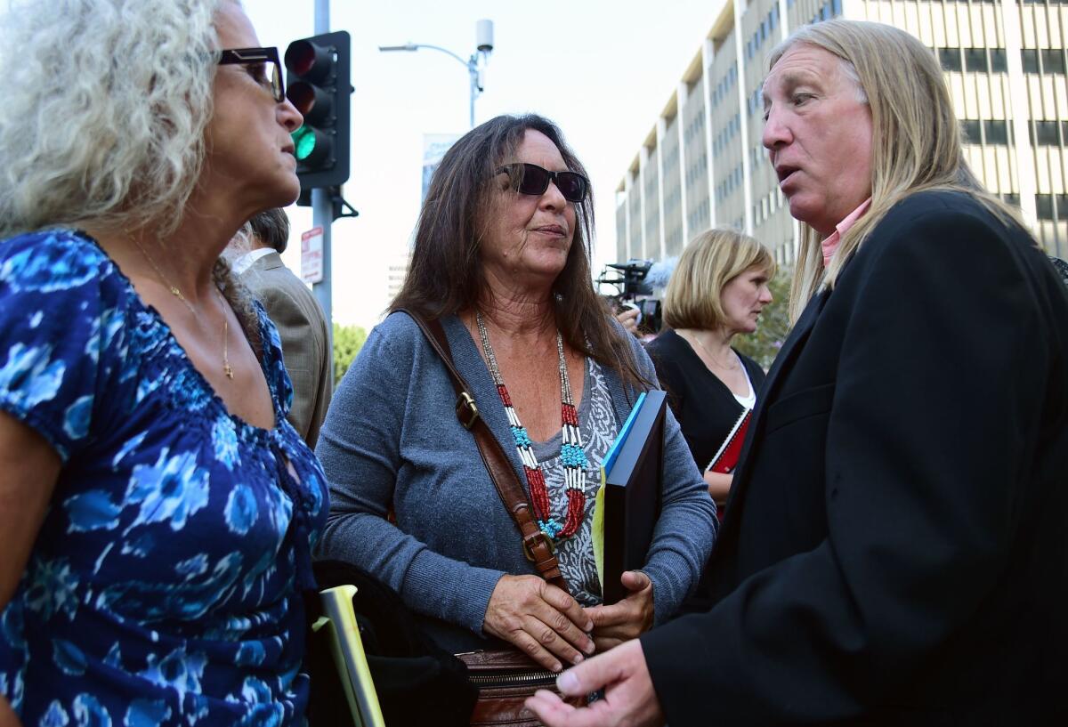 Michael Skidmore, right, talks to Janet Wolfe, left, and Marla Randall, sisters of rock musician Randy Wolfe, aka Randy California, outside the federal courthouse following the jury's verdict that Led Zeppelin did not steal portions of Wolfe's song "Taurus."