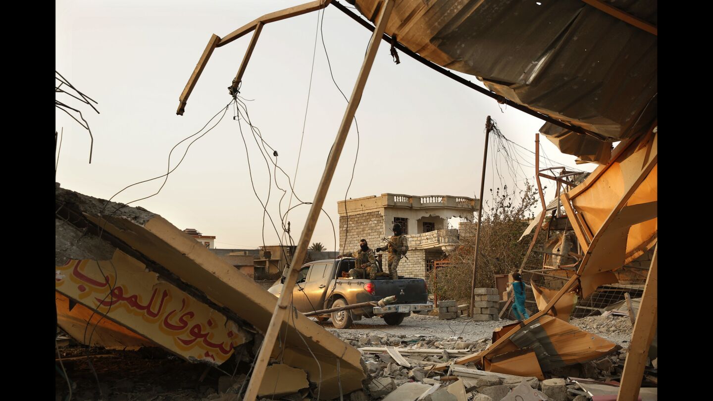 Soldiers drive through the town of Qayyarah, heavily damaged in the fighting in August and again this month as Islamic State was driven out of town.