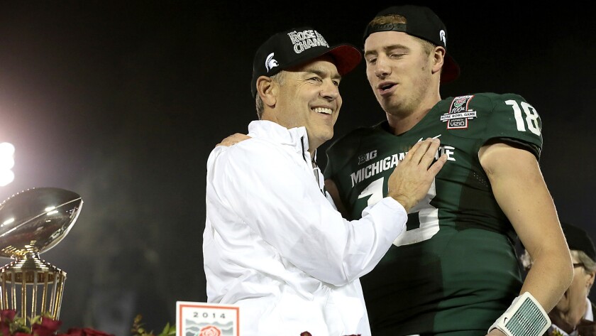 Michigan State Coach Mark Dantonio embraces quarterback Connor Cook after the Spartans defeated Stanford to win the Rose Bowl game last season.
