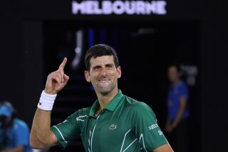 Serbia's Novak Djokovic celebrates after defeating Switzerland's Roger Federer in their semifinal match at the Australian Open tennis championship in Melbourne, Australia, Thursday, Jan. 30, 2020. (AP Photo/Lee Jin-man)