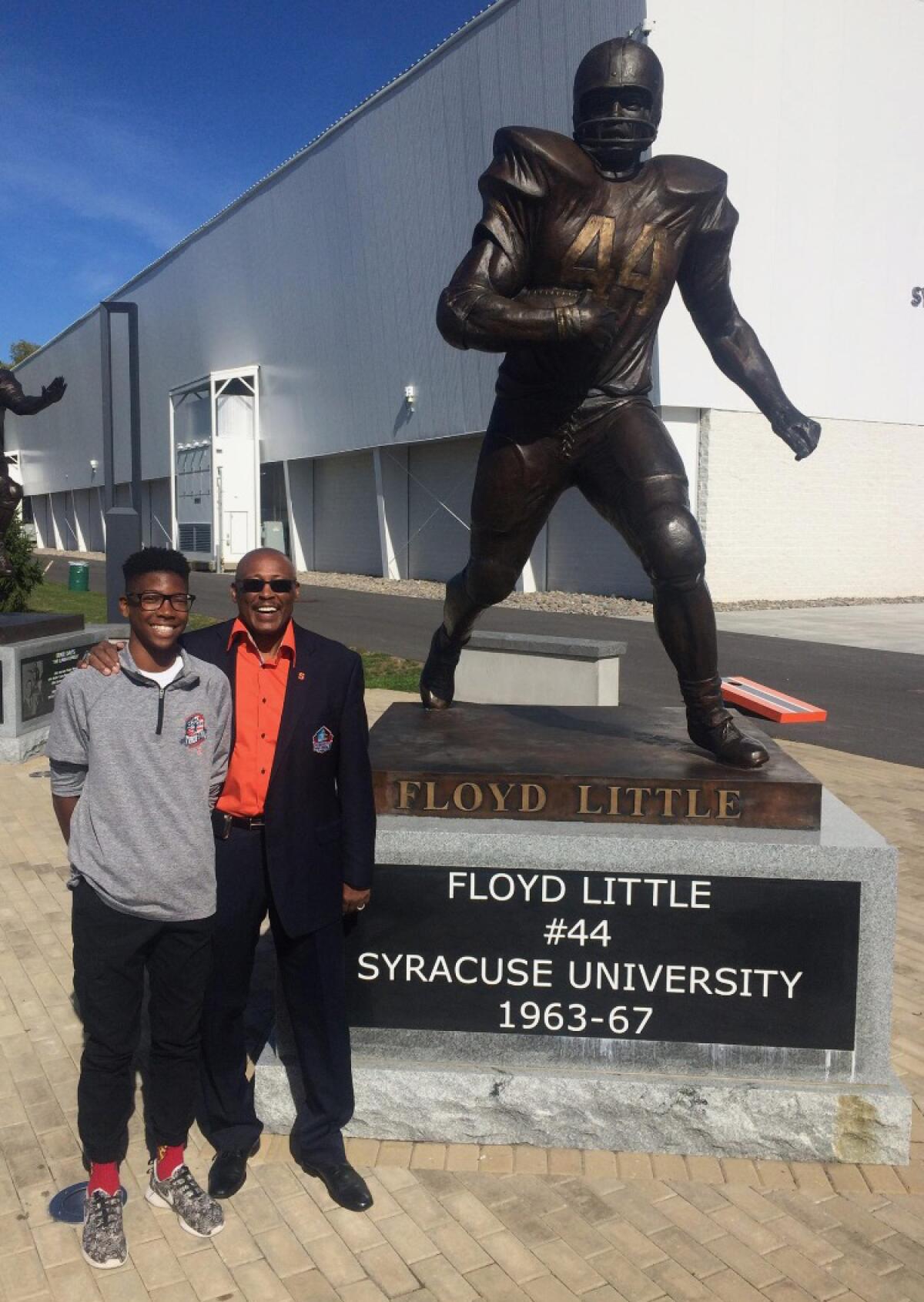 J.Michael Sturdivant stands next to his uncle, former Syracuse star and Pro Football Hall of Famer Floyd Little.
