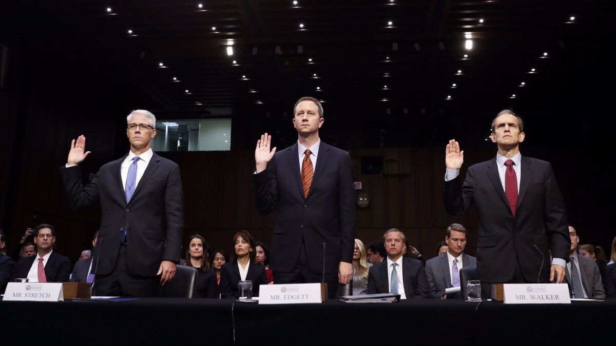 From left, Colin Stretch, general counsel for Facebook; Sean Edgett, acting general counsel for Twitter; and Kent Walker, senior vice president and general counsel for Google, prepare to testify before the Senate Select Committee on Intelligence on Wednesday.
