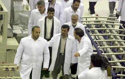 President Mahmoud Ahmadinejad, center front, tours the new factory in Esfahan that will produce uranium fuel pellets for use at the Arak research reactor.
