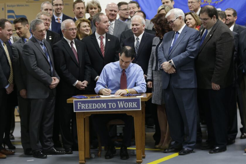 Wisconsin Gov. Scott Walker signs a right-to-work bill into law Monday, a measure he said three years ago he opposed. What changed? Presidential ambitions.