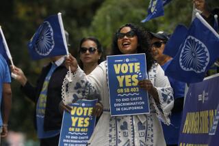 Sacramento, California-Sept. 26, 2023-Thenmozhi Soundararajan, center, of Equality Labs, leads a group pushing for a law to ban caste discrimination, SB 403, rally in front of the Capitol Annex building. They are calling for the passage of SB 403, which Governor Newsom has yet to sign. (Carolyn Cole/Los Angeles Times)