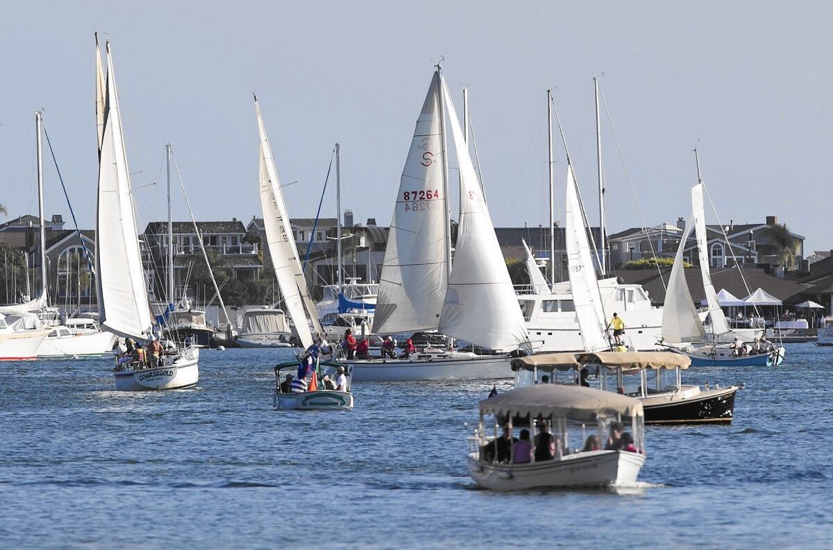 Sailboats and other water craft move through the Newport Harbor turn basin.