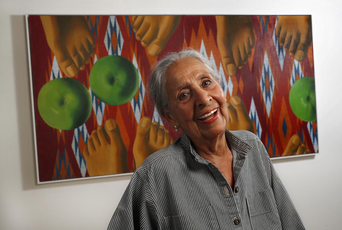 Painter Luchita Hurtado smiles before one of her canvases at the Hammer Museum in 2018