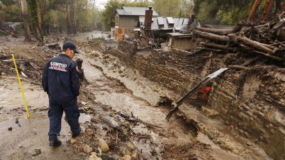 A Lompoc firefighter scouts Montecito Creek during a break between El Niño-fueled storms in March. Rising temperatures brought on by climate change will increase the frequency of strong El Niño events.