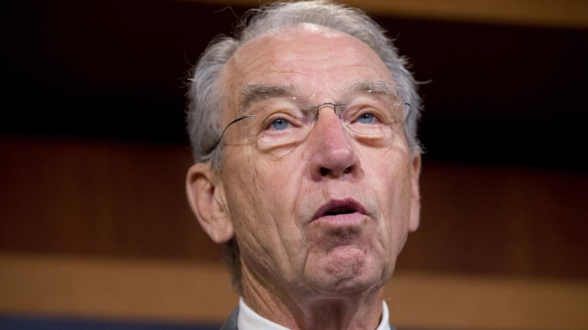 Sen. Charles E. Grassley is investigating whether immigrant youths were placed in homes with convicted criminals.