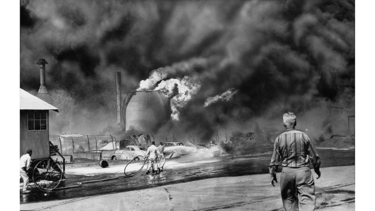 May 22, 1958: Flames and black oily smoke spew out of a storage tank as a series of fatal explosions rock the Hancock Oil Co. in Signal Hill.