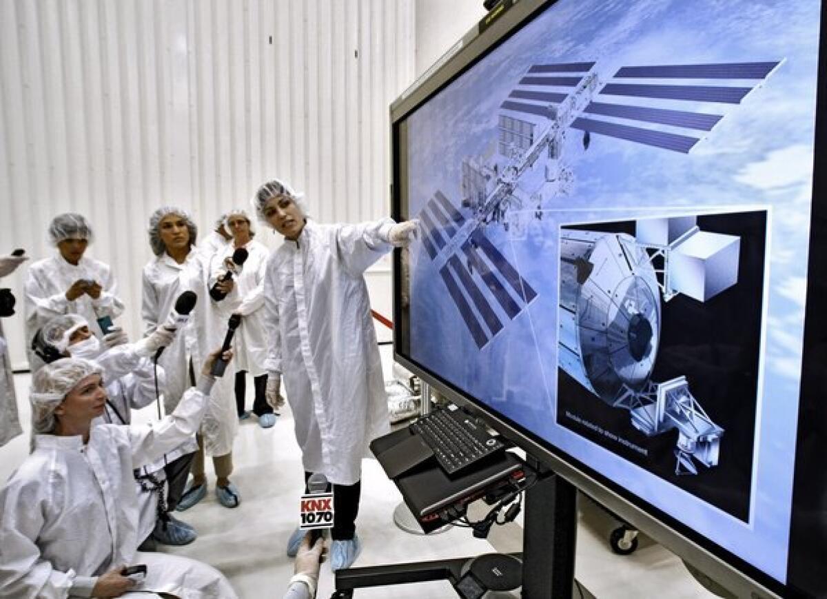 Instrument Systems Engineer for ISS-RapidScat Dragana Perkovic-Martin, right, talks to the media during to the Spacecraft Assembly Facility Cleanroom at the Jet Propulsion Laboratory on Tuesday, August 13, 2013.
