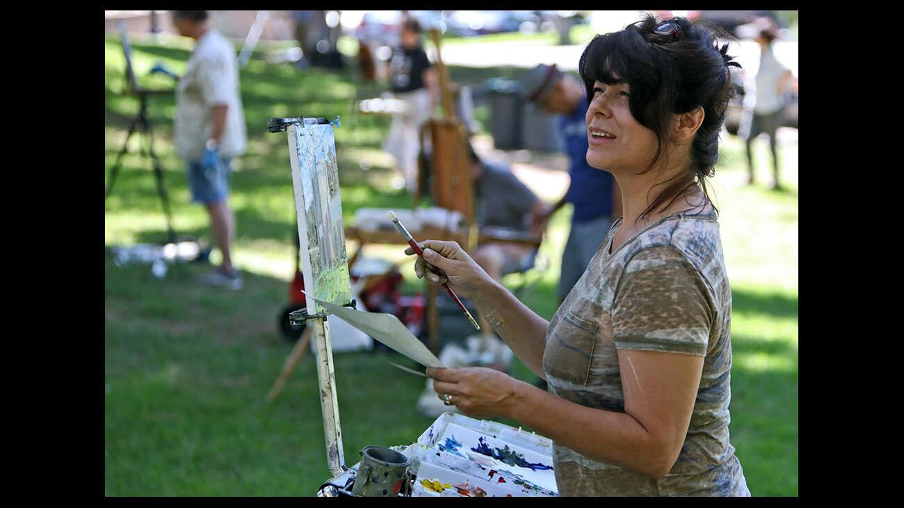 With other fellow painters in the background, Jeannine Savedra of Monrovia looks over at her subject as she paints a section of the Brand Library during a painting workshop on the ground of the Glendale landmark on Wednesday, Aug. 29, 2018. The weekly class, led by painting instructor Robert Sherrill, meets at area locations once a week. For more information, go to www.RoebrtSherrill.com