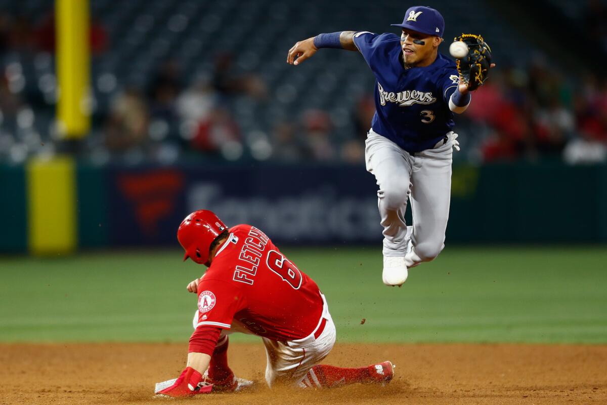 Angels third baseman David Fletcher beats the throw to Milwaukee Brewers shortstop Orlando Arcia to steal second base in the bottom of the 8th inning during an April 10 game at Angel Stadium.