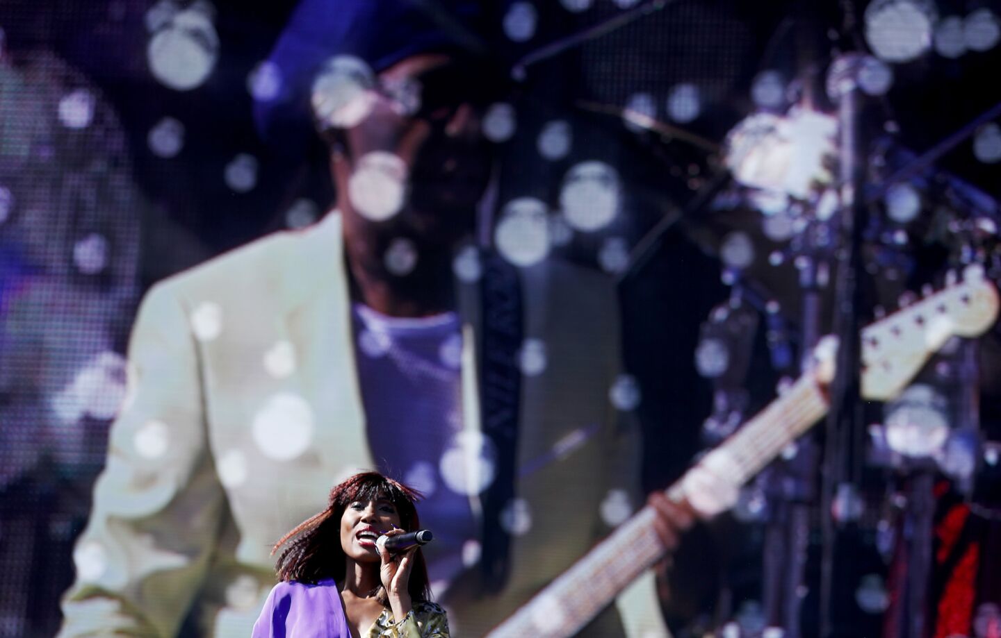 Singer Folami performs with Nile Rodgers, background, during the Coachella Music and Arts Festival in Indio on, April 14.