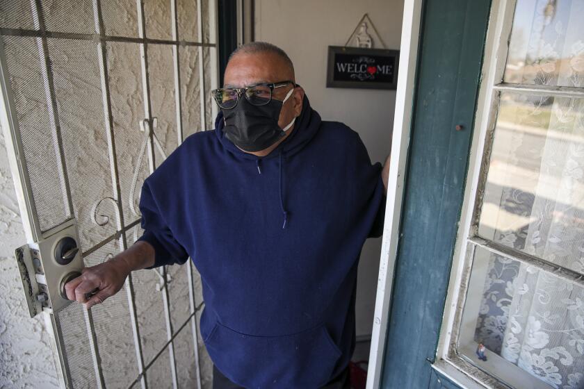 Monterey Park, CA - February 20: Luis Parocua, 65, a retired hospital worker, who got vaccinated, continue to practice safety measures like wearing face masks when stepping out of home on Saturday, Feb. 20, 2021 in Monterey Park, CA.(Irfan Khan / Los Angeles Times)