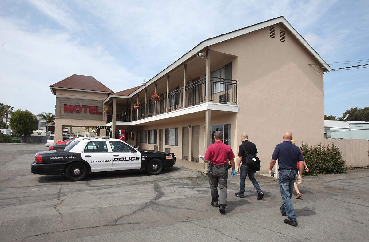 A team of code enforcement officers and county health department inspectors check on conditions at the Sandpiper Motel in Costa Mesa with help from the Costa Mesa PD.