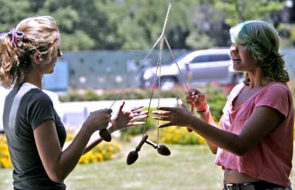 Shayna Niles, left, and Alia Spring, both 17 and from Granada Hills, make a Viking Whip Cord during the annual St. Hans Day Picnic of the Edgar Grieg Lodge of the Sons of Norway held at Lutheran Church of the Foothills in La Canada Flintridge.