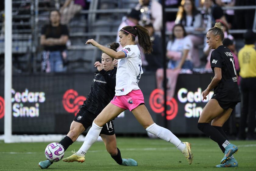 Angel City's Paige Nielsen, far left, and M.A. Vignola, right, defend San Diego's Alex Morgan on April 23, 2023.