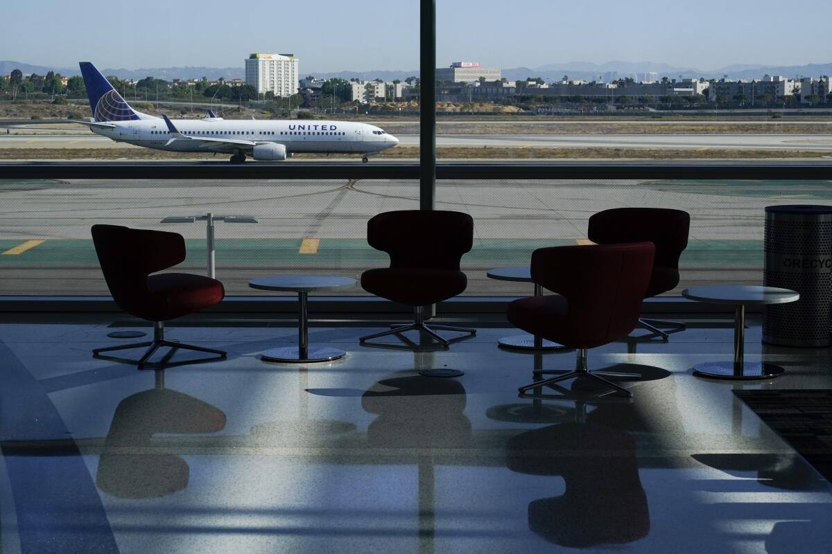 A window at LAX's new West Gates facility looks out on an airplane