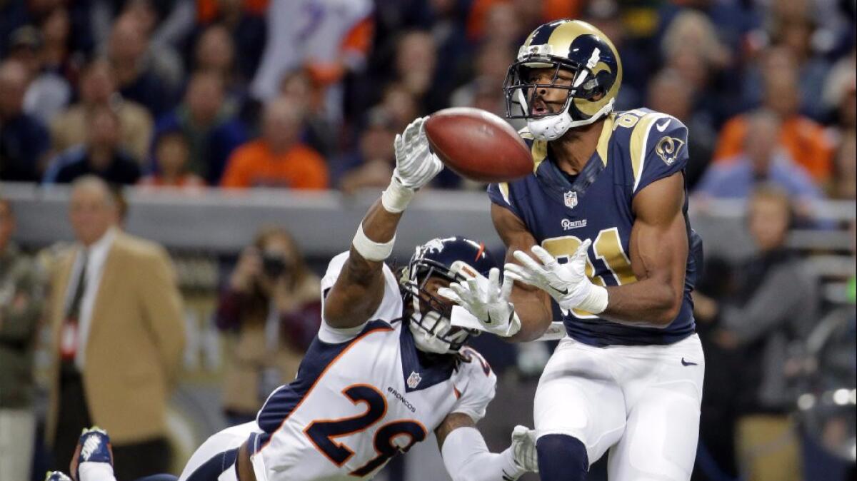 Rams receiver Kenny Britt catches a 63-yard pass for a touchdown in front of Broncos cornerback Bradley Robey during a game on Nov. 16, 2014.