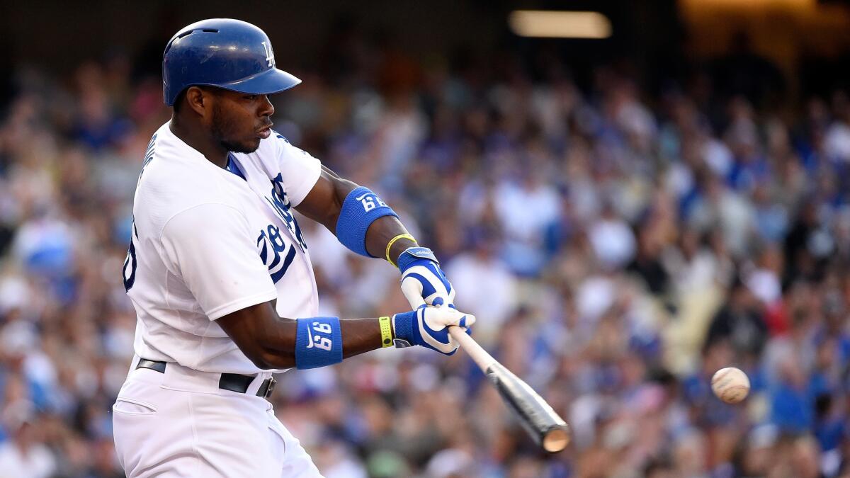 Dodgers right fielder Yasiel Puig hits a single during the third inning of the team's 5-3 loss to the Pittsburgh Pirates on Sunday.