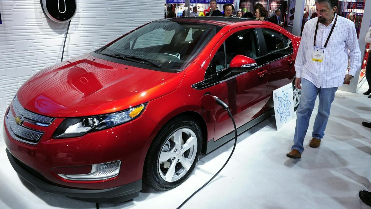 A Chevrolet Volt hybrid-electric car is plugged into GE's Residential WattStation at the 2011 International Consumer Electronics Show. General Motors Co. said Monday that it will scrap the Volt, considered the future of the company when it hit the road in 2010.