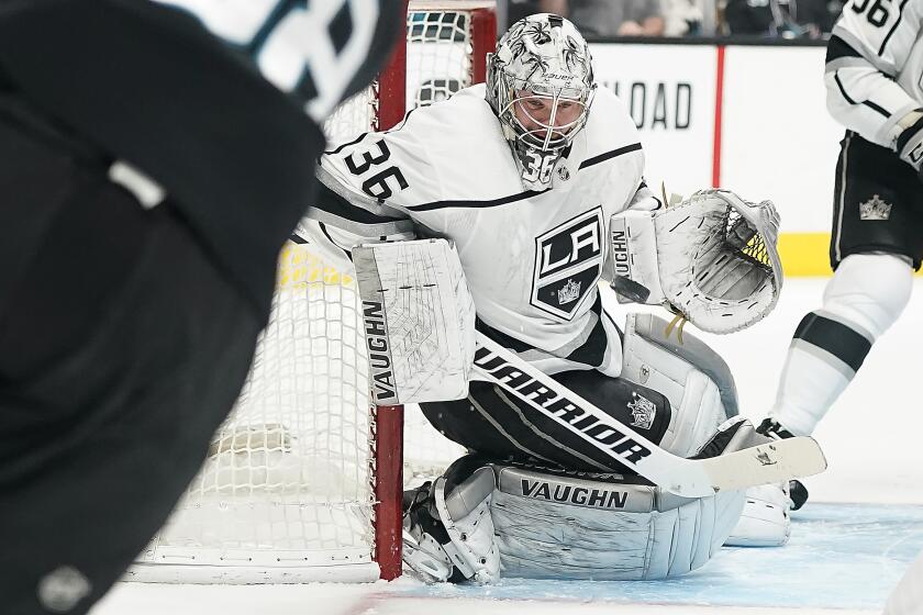 Los Angeles Kings goaltender Jack Campbell (36) blocks a shot by San Jose Sharks defenseman Brent Burns (88) during the first period of an NHL hockey game in San Jose, Calif., Friday, Dec. 27, 2019. (AP Photo/Tony Avelar)