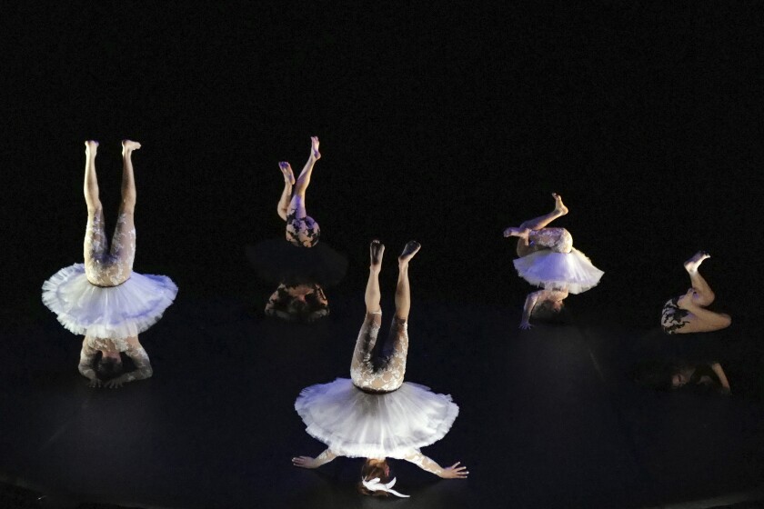 Dancers, from left to right, Joaquin Medina Caligari from Uruguay, Tasha Petersen from Argentina, Valentino Martinetti from Argentina, Marius Fouilland from France and Lucille Chalopin from Paris, of the Eolienne company perform "Le Lac des Cygnes" by Florence Caillon, based on Tchaikovsky's Swan Lake during the BIAC, International Circus Arts Biennale, in Marseille, south of France, Thursday, Feb. 4, 2021. The fourth edition of the global Circus Biennale is demonstrating how the performing arts have a way of flourishing in between the cracks, celebrating the death-defying and spine stretching arts that go behind the storied spectacle. (AP Photo/Francois Mori)