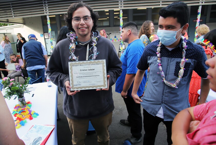 Cristian Salazar celebrates Thursday graduating from Newport-Mesa Unified's STEP program during a ceremony in Costa Mesa.